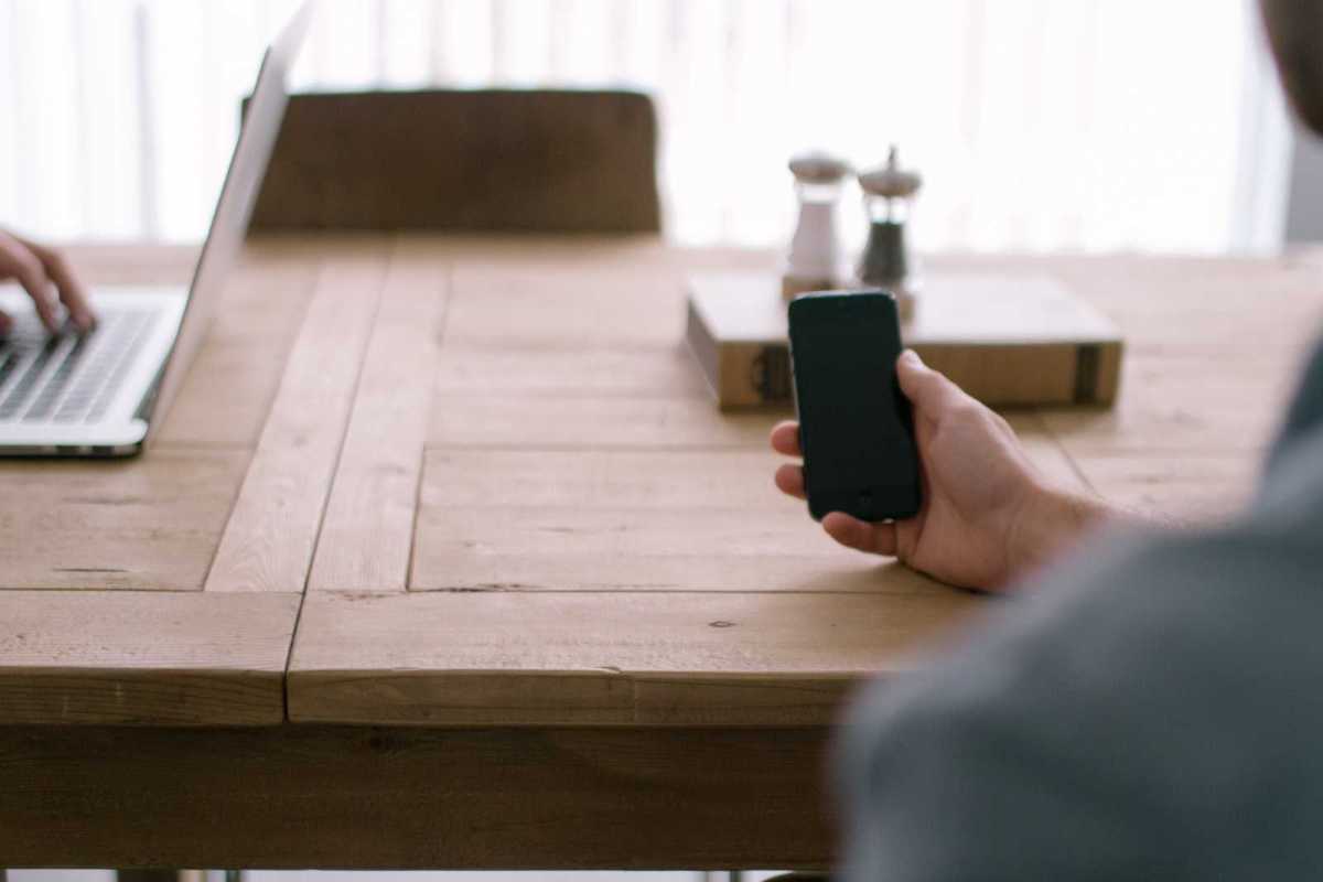 person smartphone office table